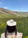 Woman with Hat in Lush Mountain Meadow