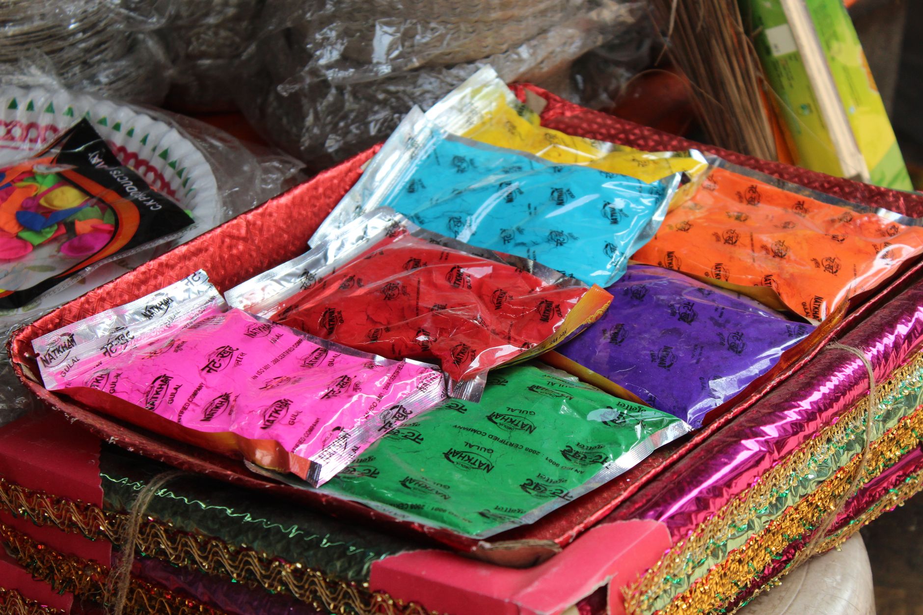 Colorful Holi powders on display in a Kolkata market, capturing the festive spirit of India's festival of colors.