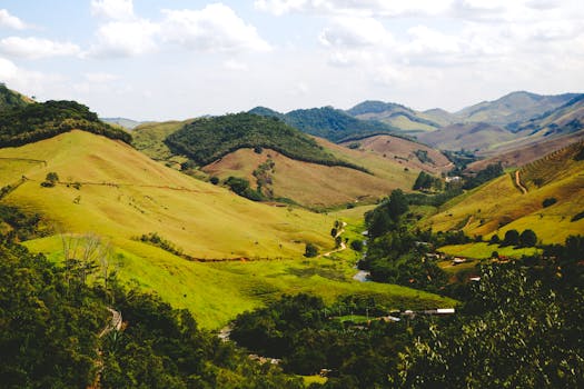 Beautiful mountain valley landscape with green hills and clear sky.