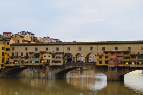 Free Historic Ponte Vecchio in Florence, Italy, beautifully captured at dusk with serene river reflection. Stock Photo