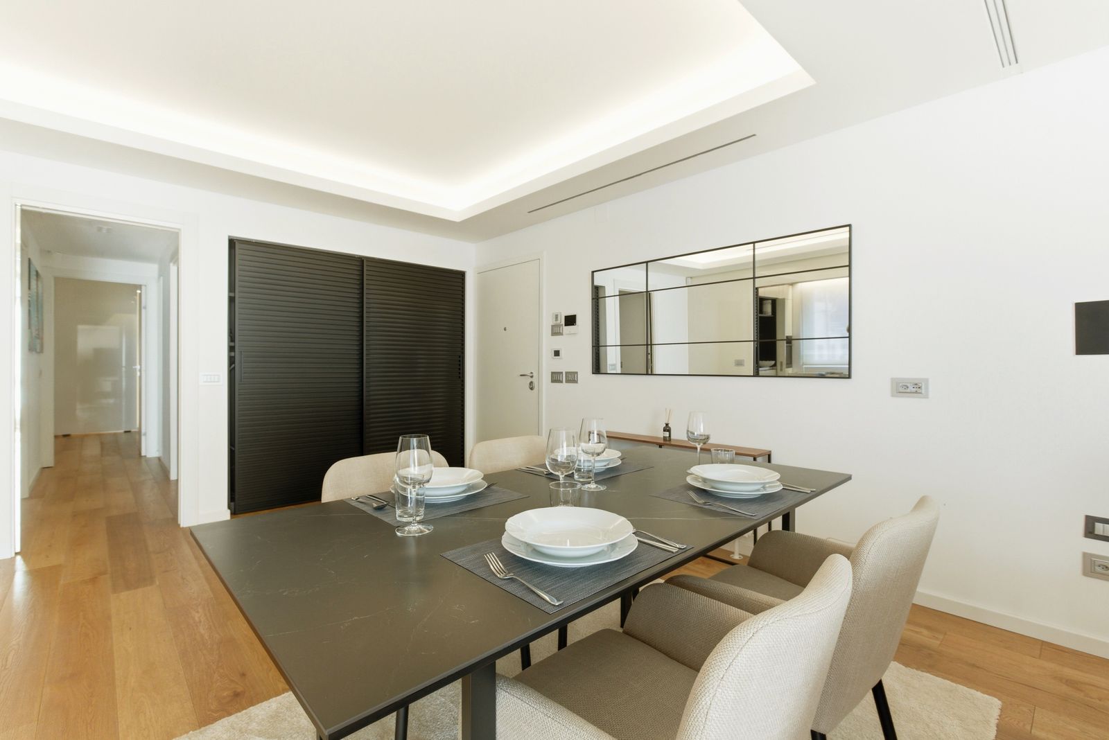 Elegant modern dining room with neutral furniture and warm wood finishes