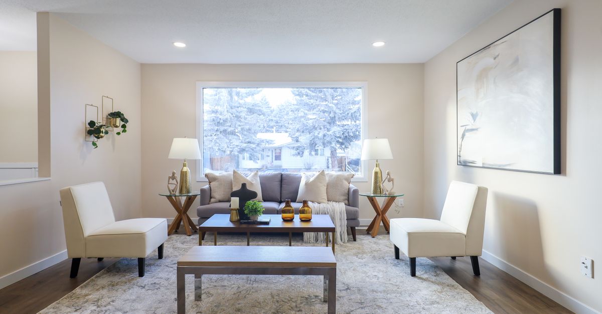 Stylish living room featuring chic furniture and a snowy window view in Edmonton.