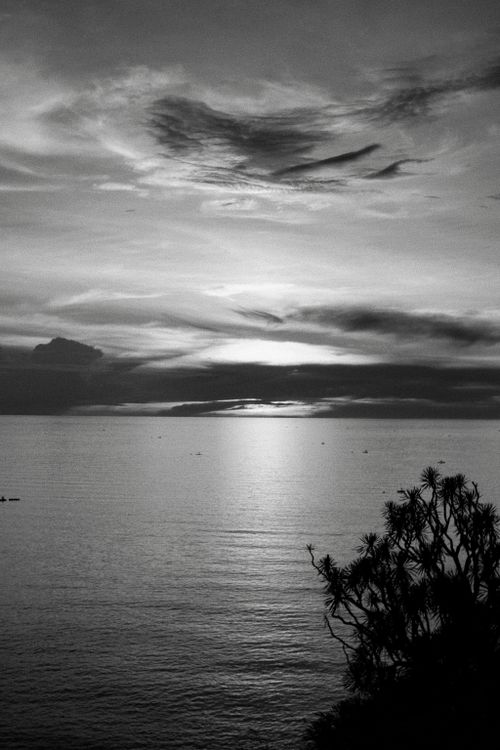 Free Tranquil sunset over the sea in Gorontalo, Indonesia, captured in monochrome. Stock Photo