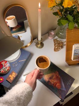A warm, inviting desk scene with coffee, candle, and Van Gogh book, perfect for a cozy lifestyle concept.