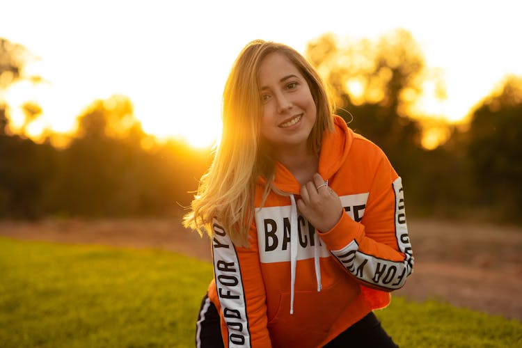 Woman In Orange And White Hoodie Smiling