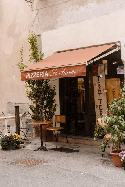 Cozy corner pizzeria with vintage decor in a quaint Italian street, perfect for casual dining.