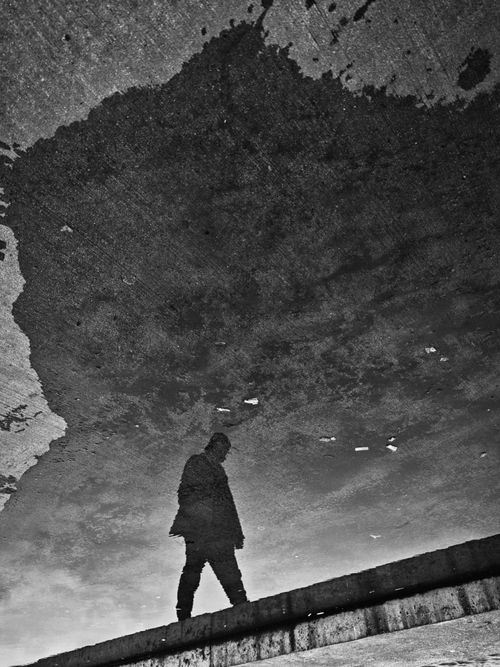 Free Artistic silhouette of a person reflected in a water puddle, İstanbul street. Stock Photo