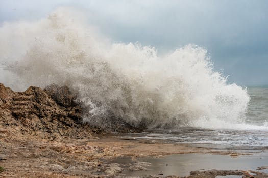 Powerful waves crash on the rocky coast of Cullera, Spain, showcasing nature's strength.