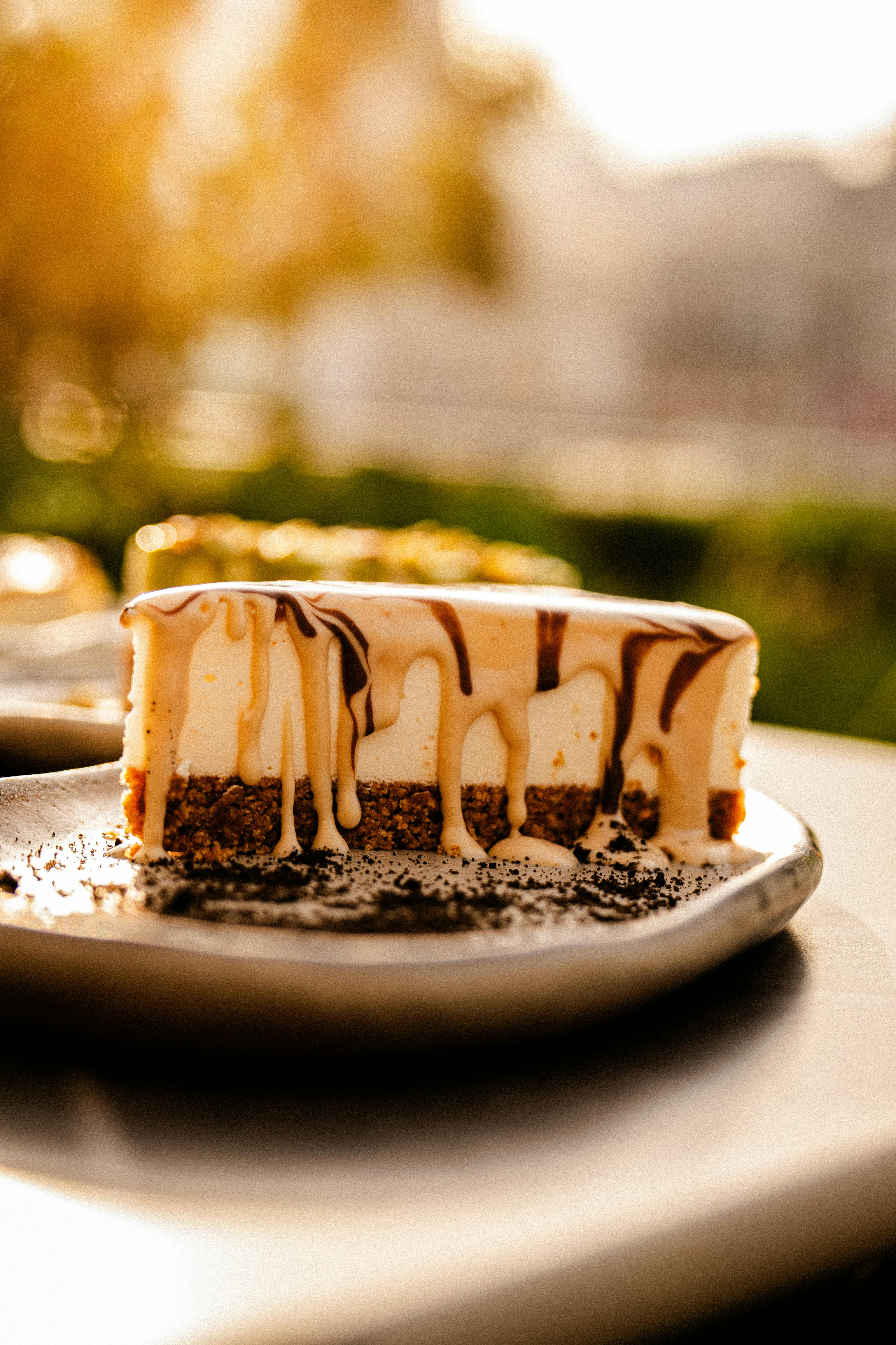 Creamy cheesecake slice with chocolate drizzle at a Dubai café.