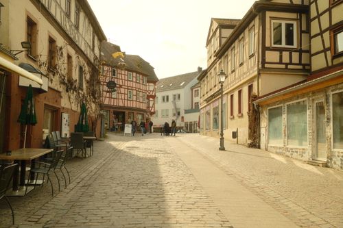 Free Sunlit cobblestone street with historic buildings in Lor-am-Main, Germany. Stock Photo