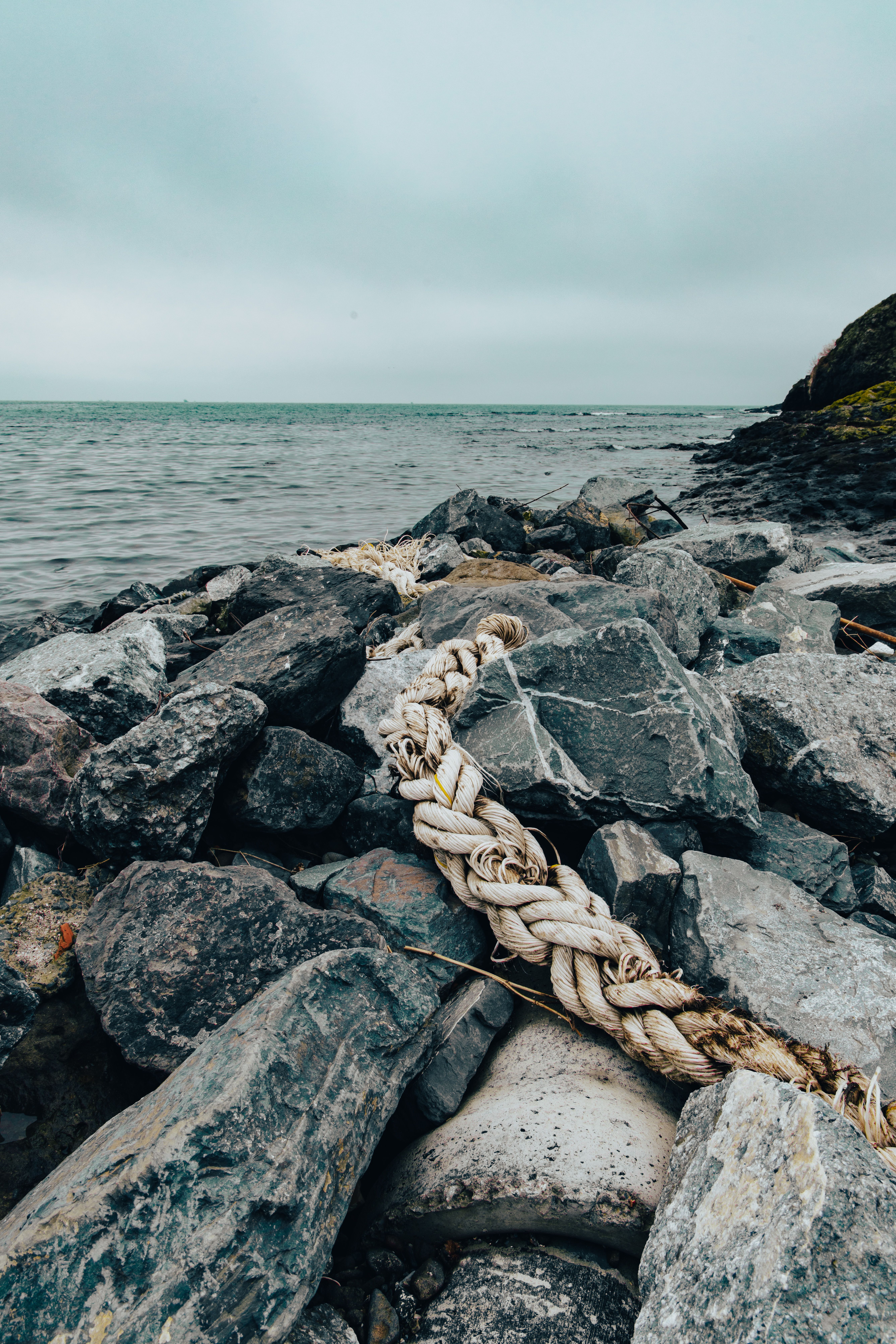 Coastal Rocks with Weathered Rope On the Shore · Free Stock Photo