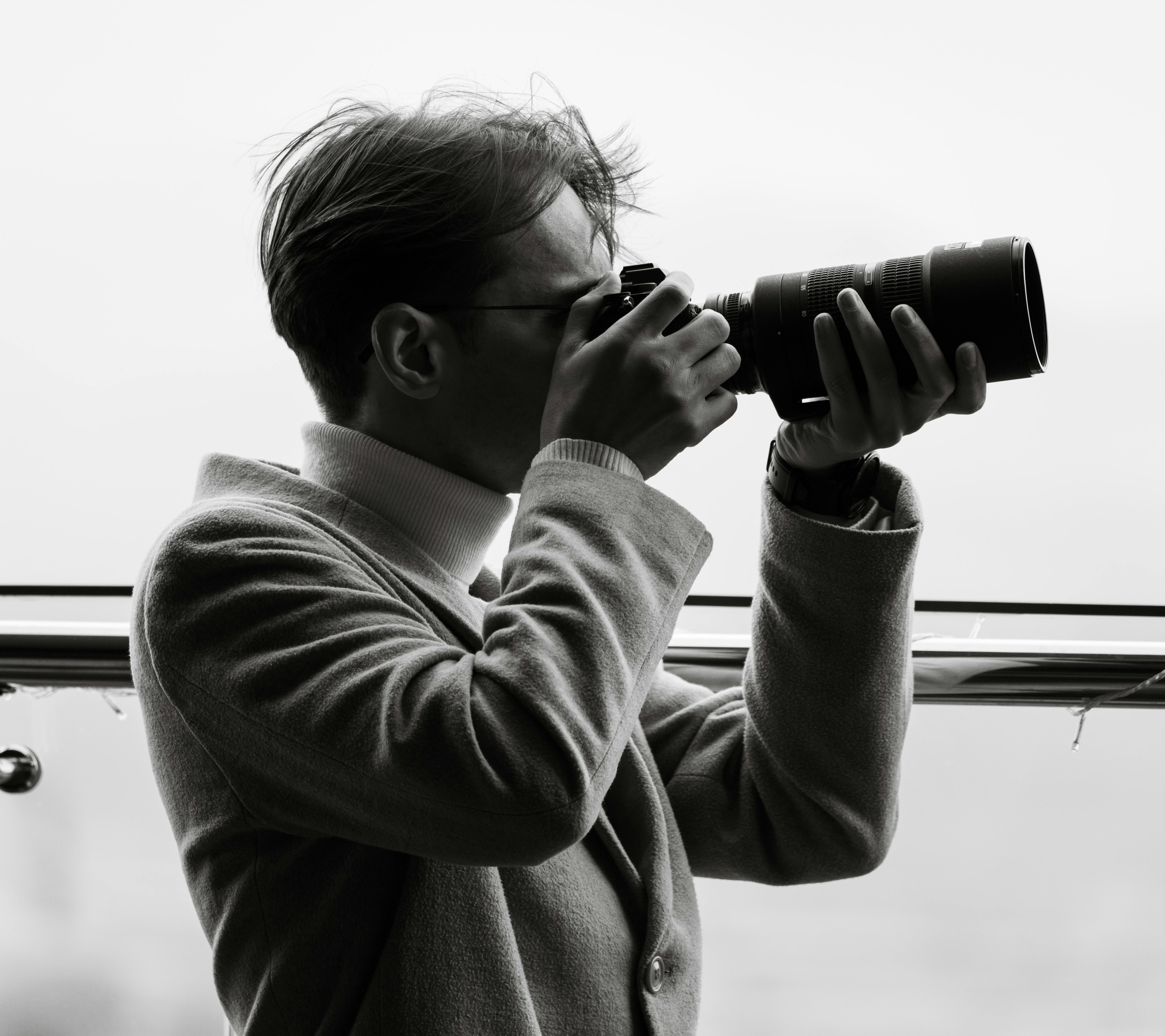 Black and White Portrait of Photographer in Action