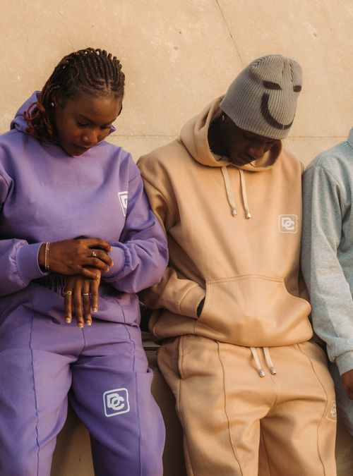 Free Young adults in stylish streetwear captured in a relaxed urban setting. Stock Photo