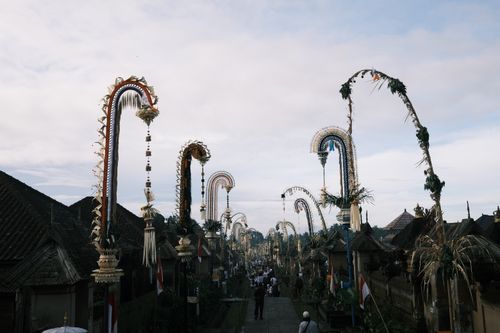 Free A vibrant Balinese street adorned with festive penjor poles during a cultural celebration. Stock Photo