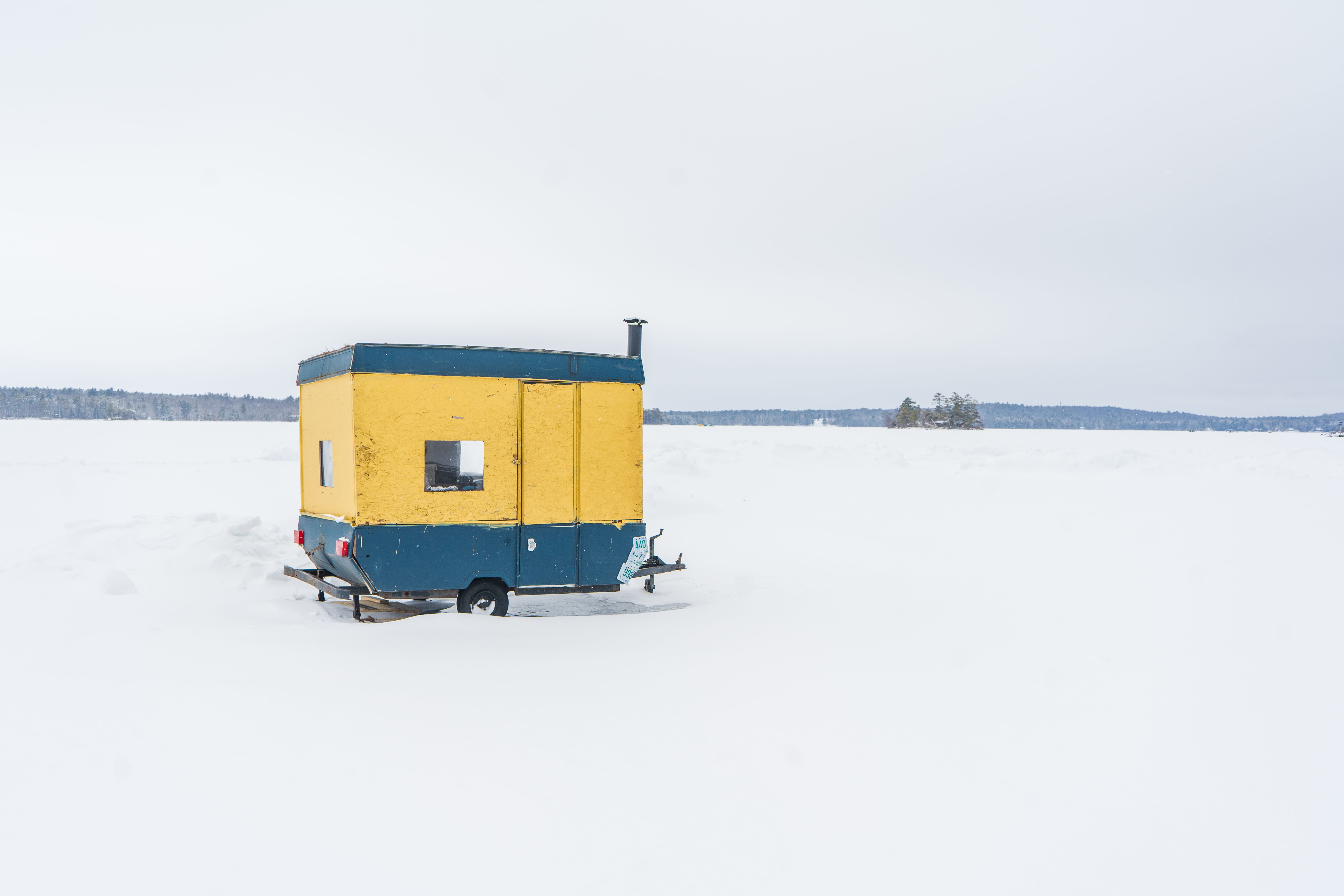 Vibrant Ice Fishing Shack on Frozen Lake · Free Stock Photo