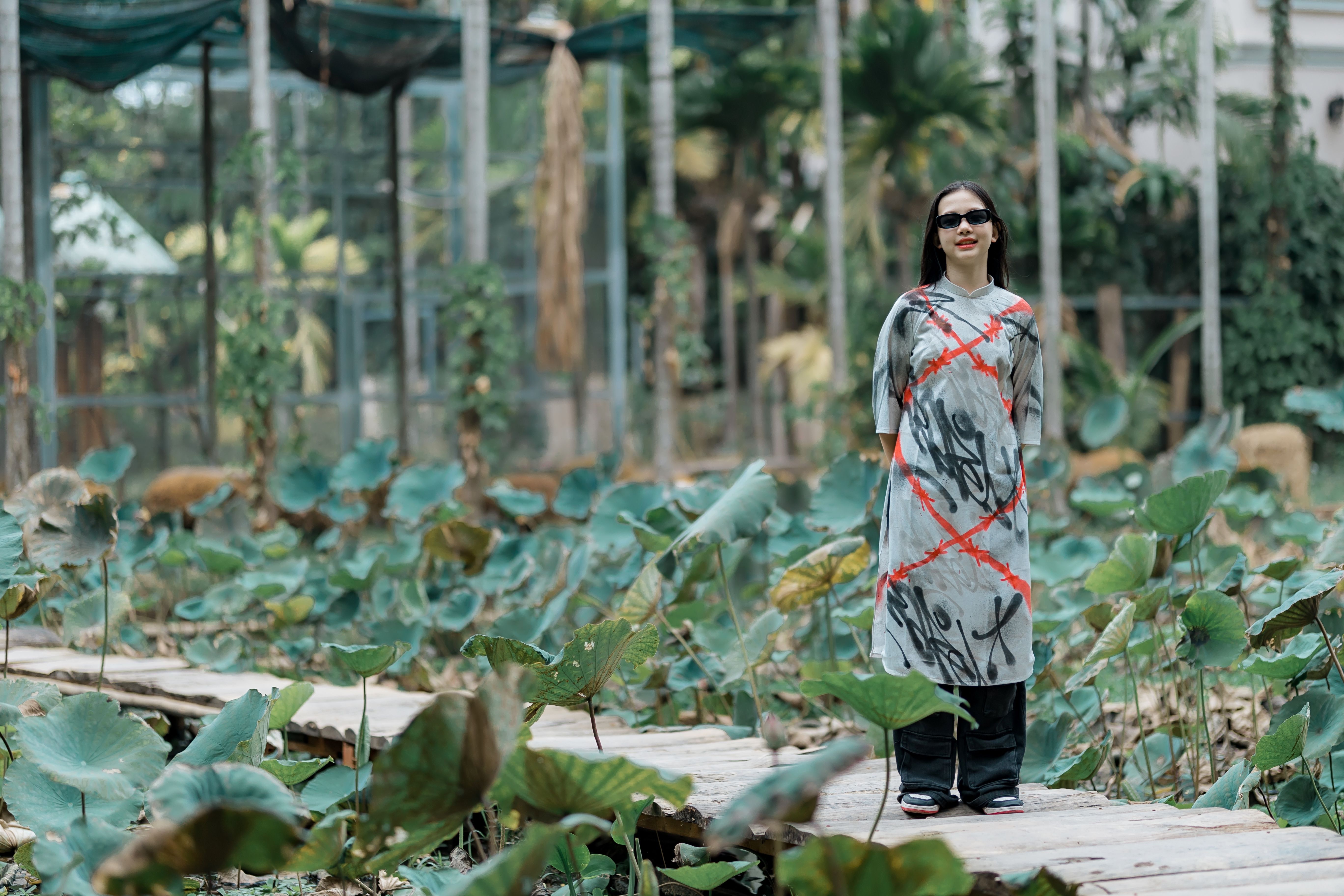 Woman in Traditional Dress on Wooden Pathway · Free Stock Photo