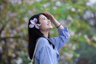 Smiling Woman with Flower in Hair Outdoors