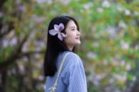Young Woman with Flower in Hair in Hanoi Park