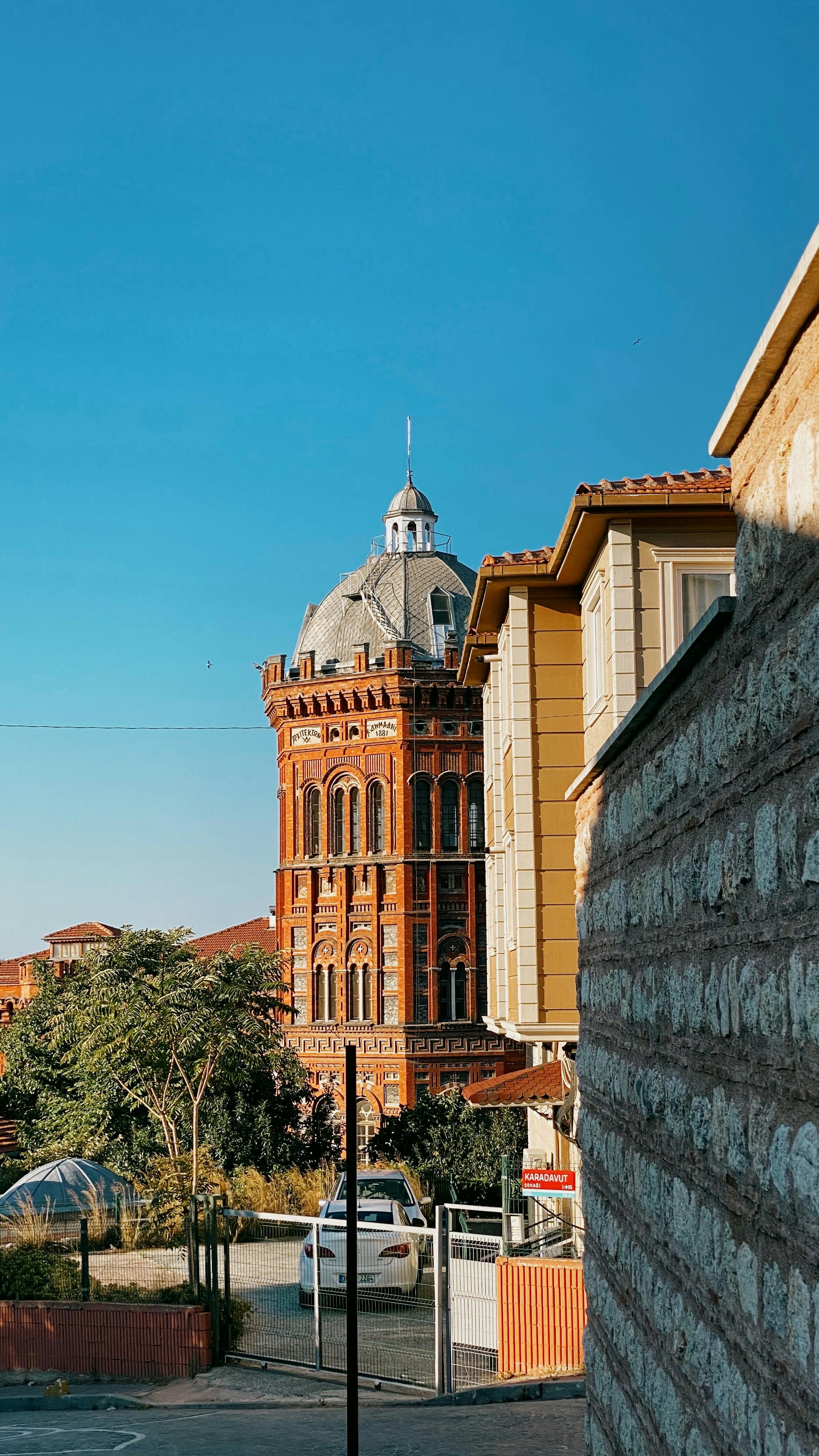Historic Phanar Greek Orthodox College under a bright blue sky in Istanbul, Türkiye.