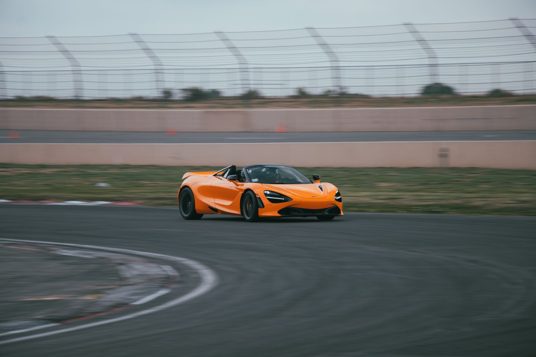 winger accelerating through orange cones on a wet football pitch during an early morning speed session