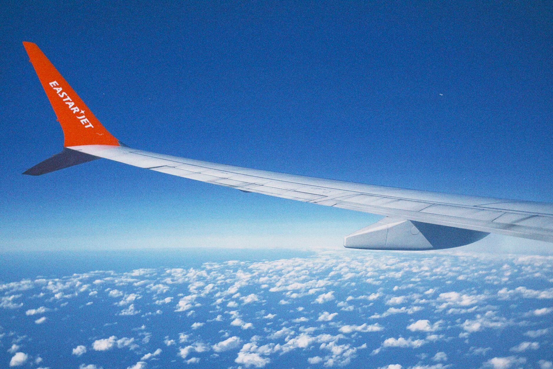 Scenic view of clouds and airplane wing from Eastar Jet flight over South Korea.