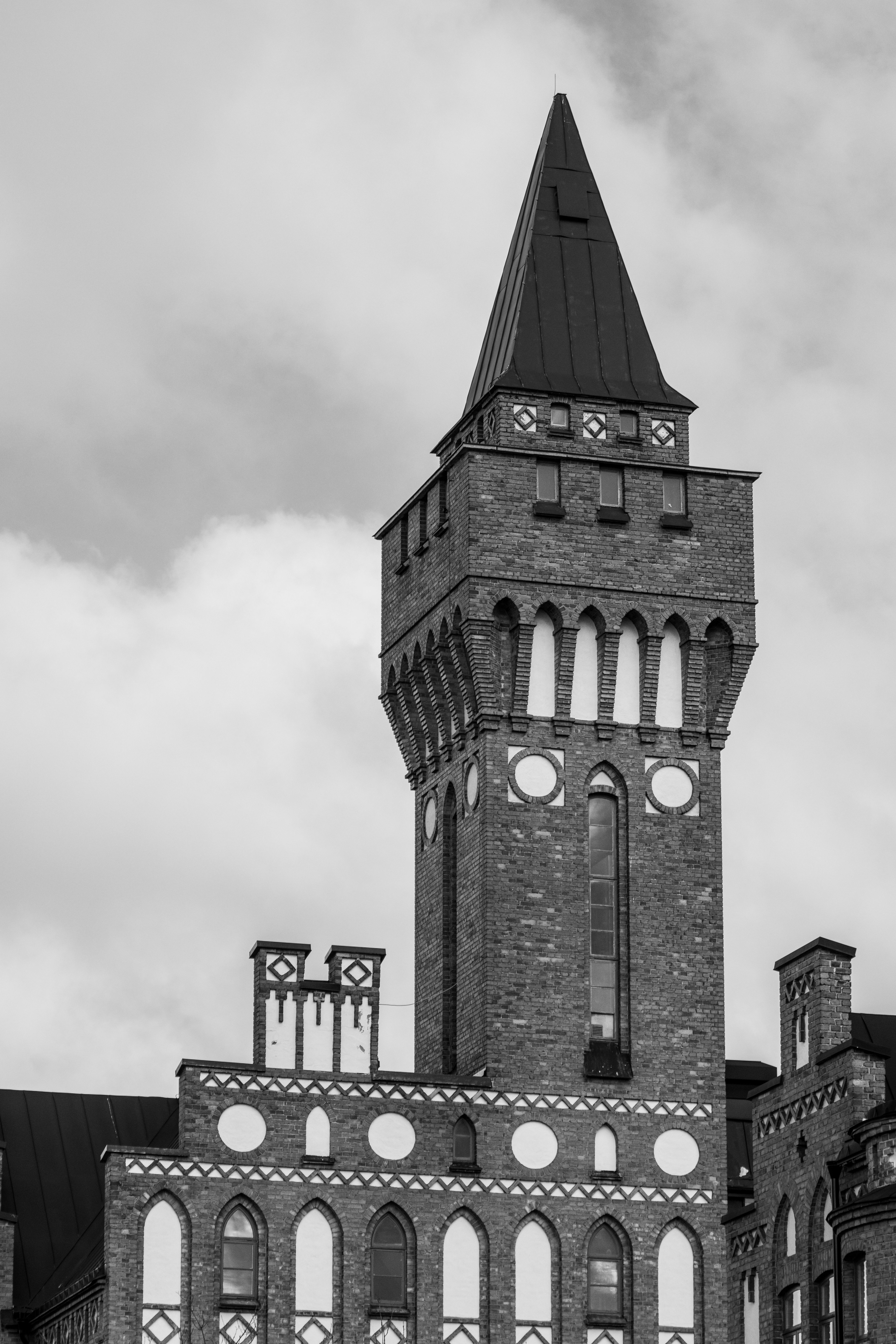 Gothic Style Brick Tower Against Cloudy Sky · Free Stock Photo