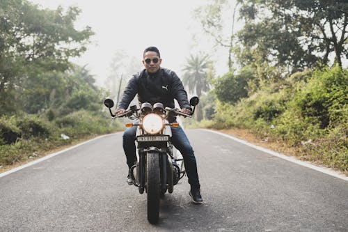 Man In Black Jacket Riding Motorcycle On Road