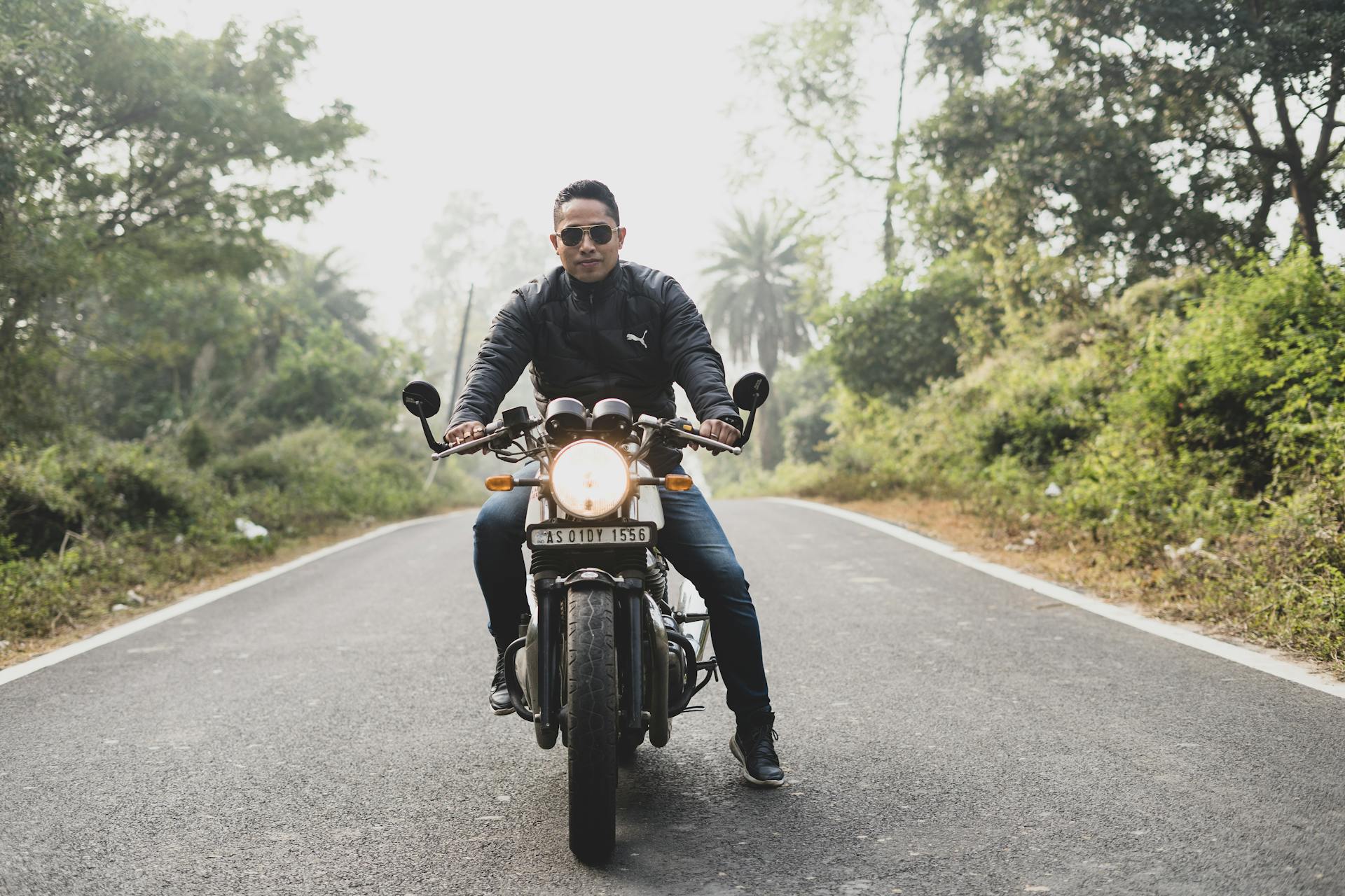 Man In Black Jacket Riding Motorcycle On Road