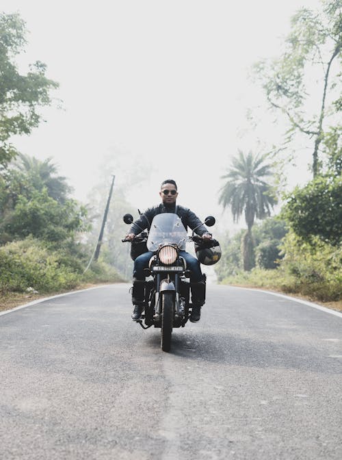 Man Riding Motorcycle On Road
