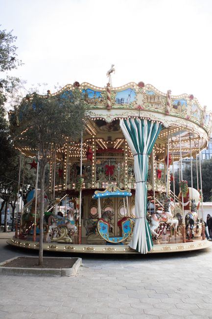 Charming vintage carousel in a park setting, captured during daylight. Ideal for themes of nostalgia and childhood joy.