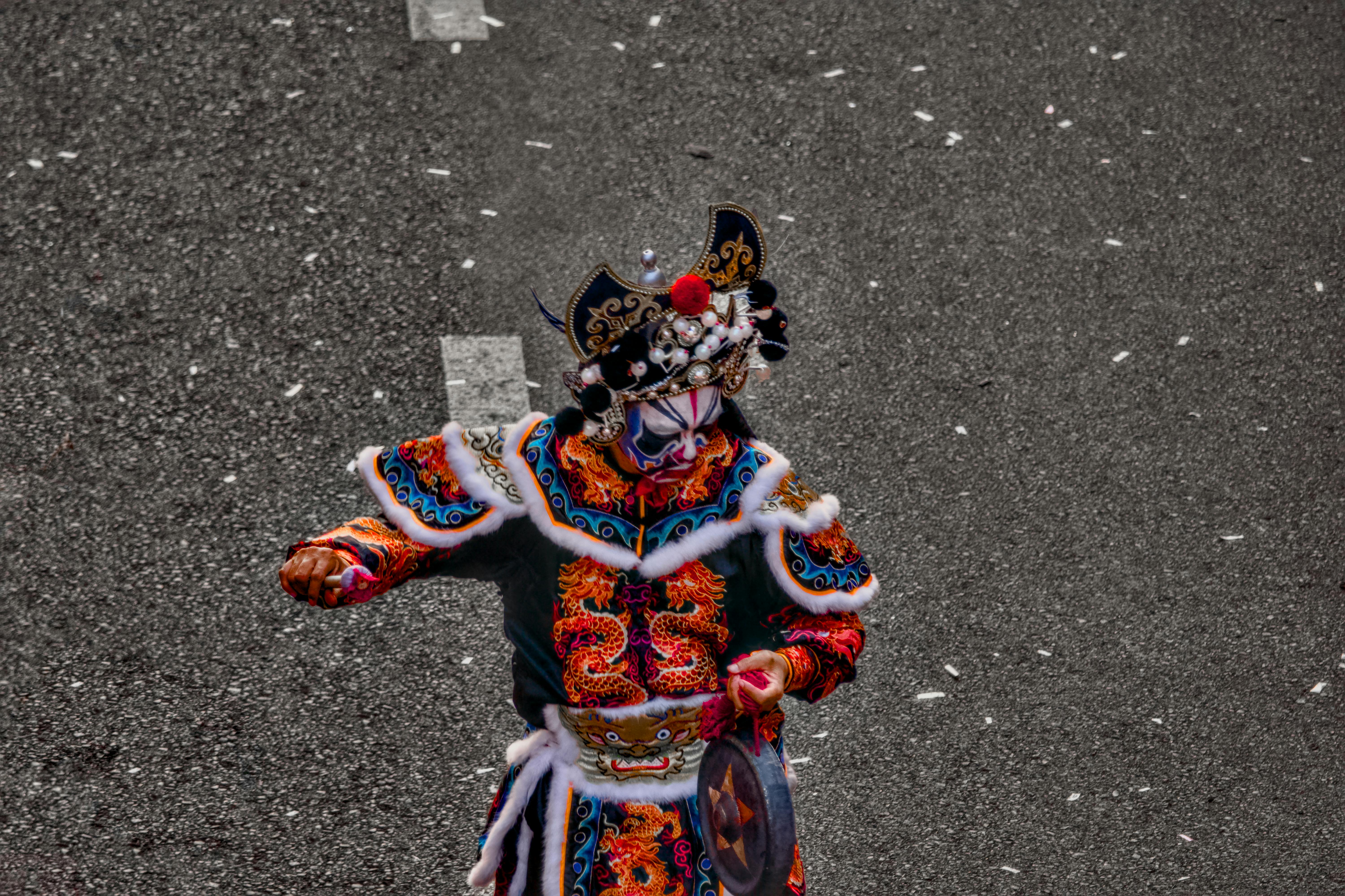 A vibrantly dressed performer in traditional costume, showcasing cultural heritage and artistic design.