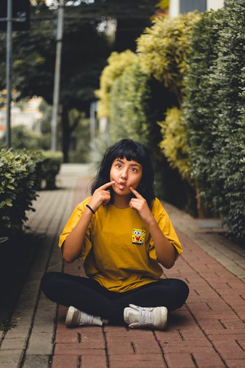 Woman In Yellow Long Sleeved Shirt And Black Pants 