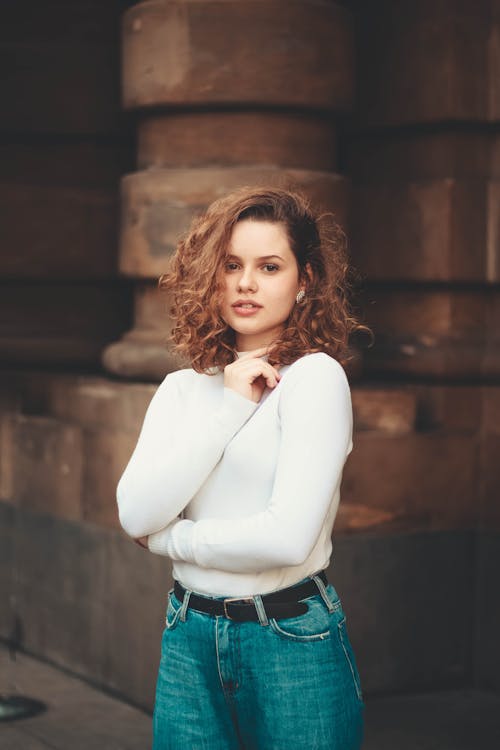 Woman In White Top And Blue Denim Bottoms