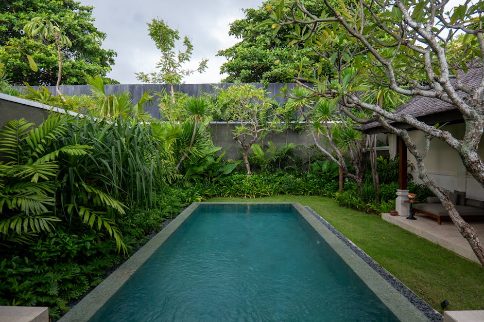 Luxurious villa pool surrounded by lush tropical greenery