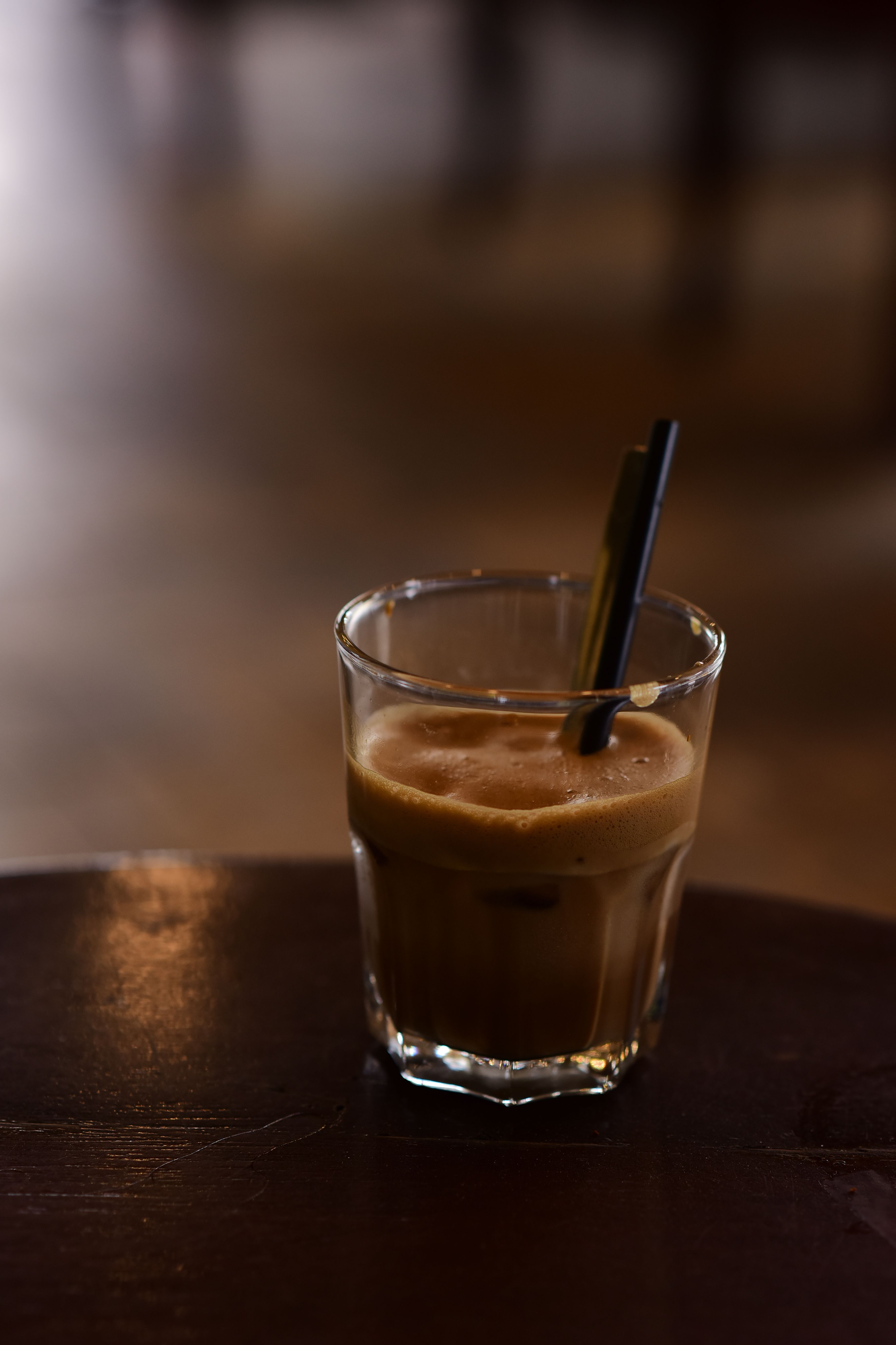 Close-up of Frothy Iced Coffee in Café Setting · Free Stock Photo