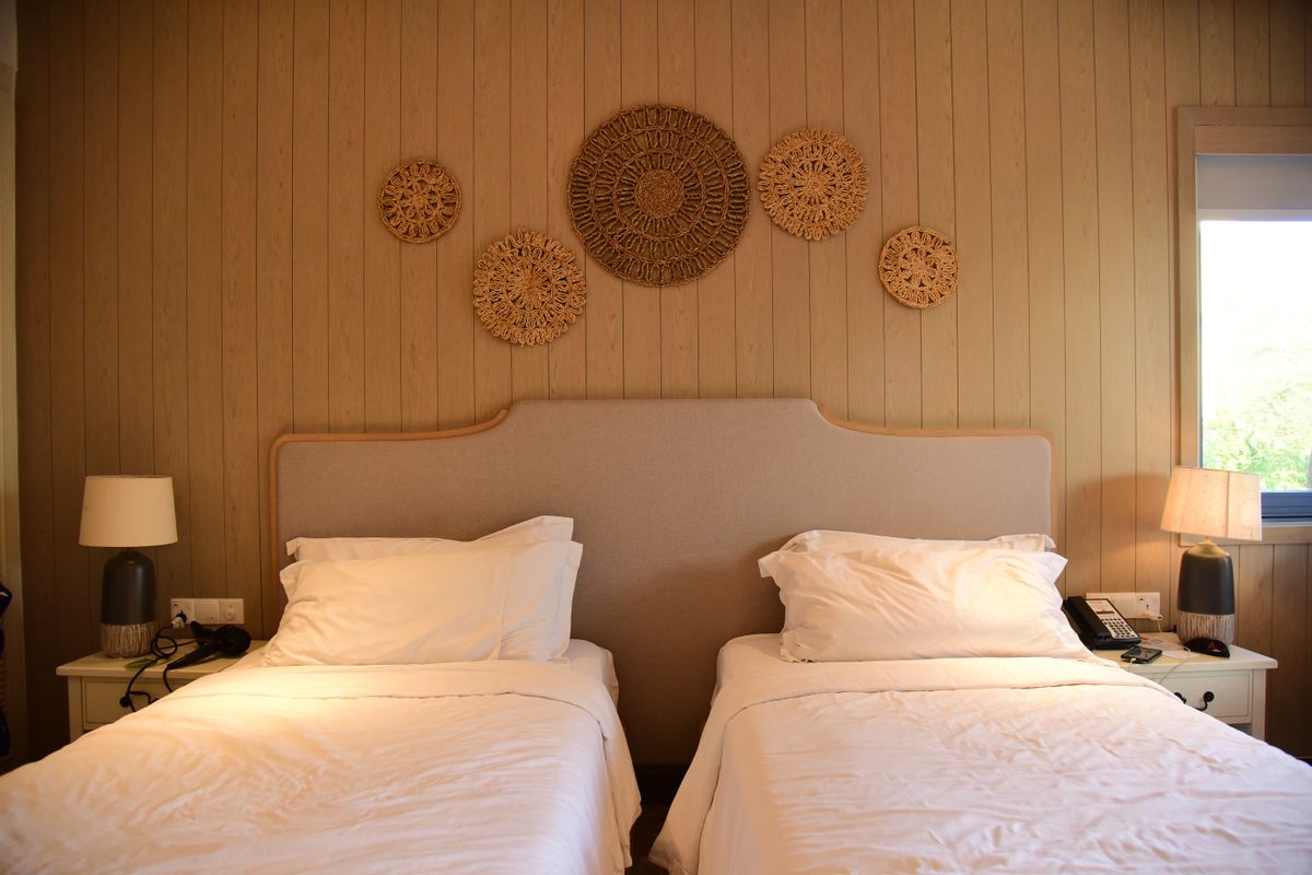 A bright guest room with two separate single beds