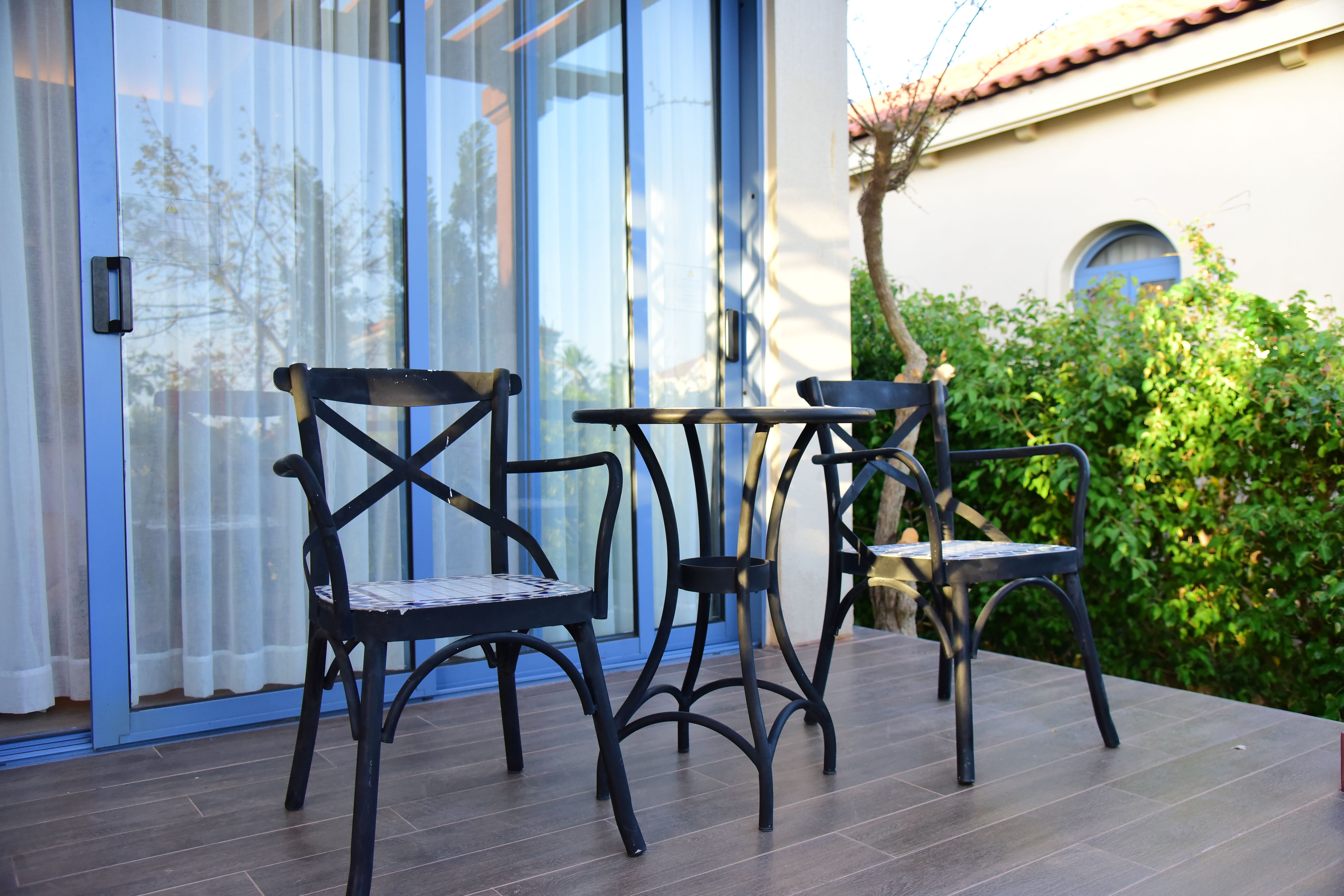 Outdoor patio with iron chairs and a table