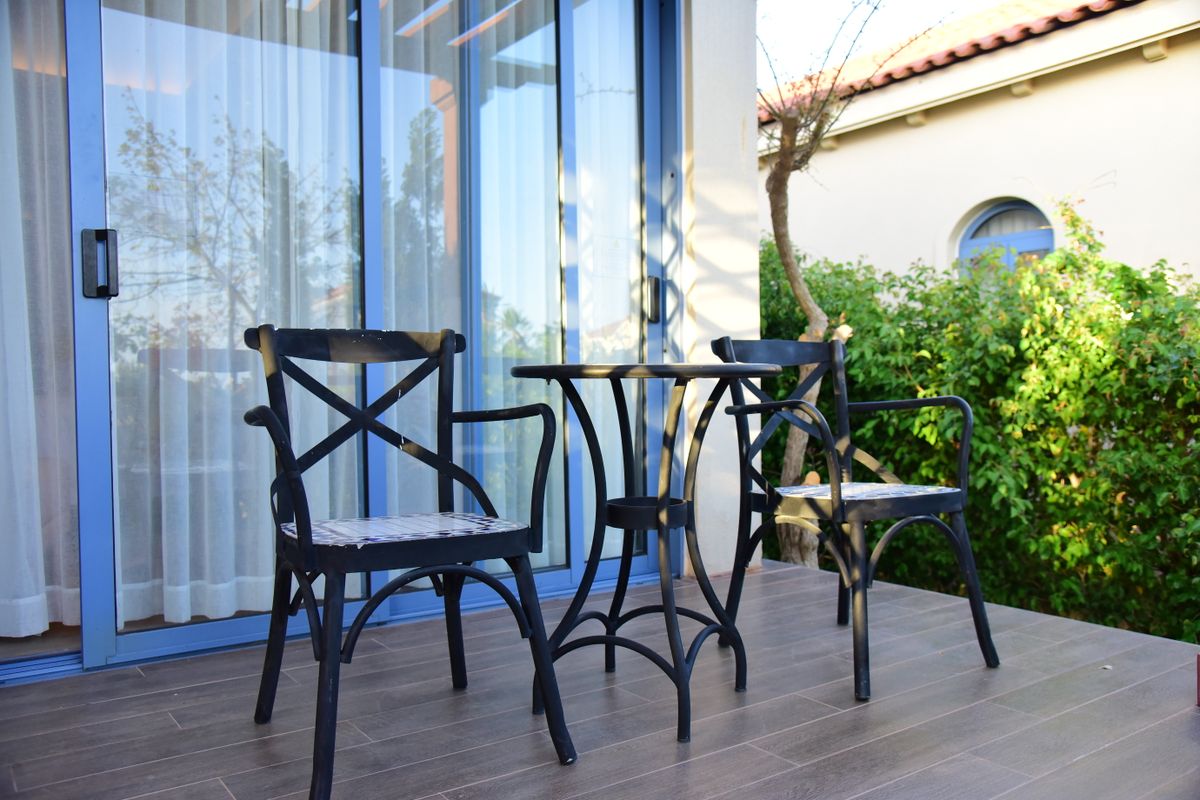 Outdoor patio with iron chairs and a table