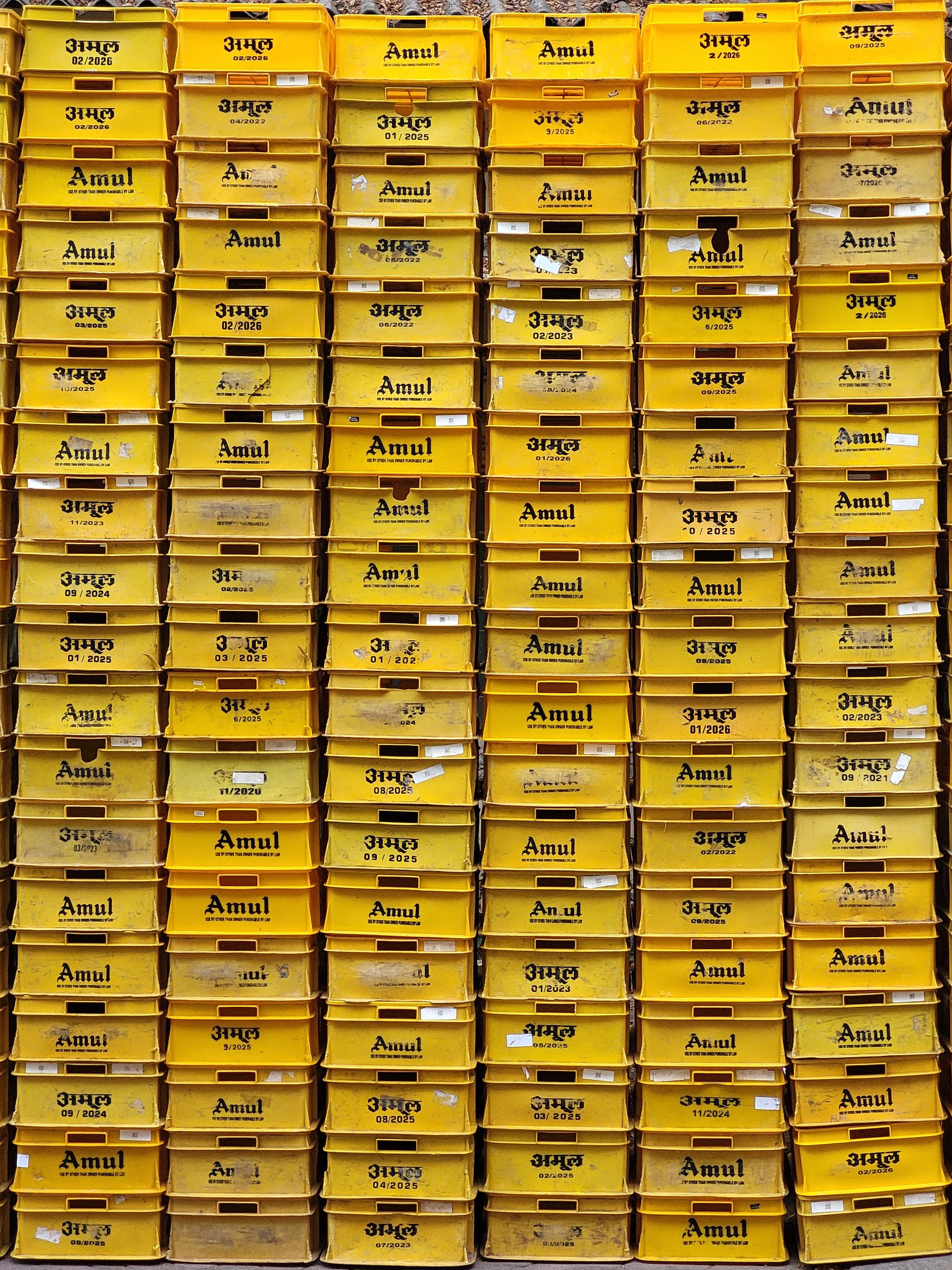 Rows of produce crates stacked in an Indian warehouse