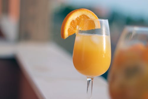 Free Orange Juice in Clear Drinking Glass Stock Photo