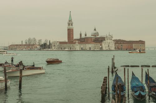 Free Tranquil view of San Giorgio Maggiore in Venice with gondolas and boats on a cloudy day. Stock Photo