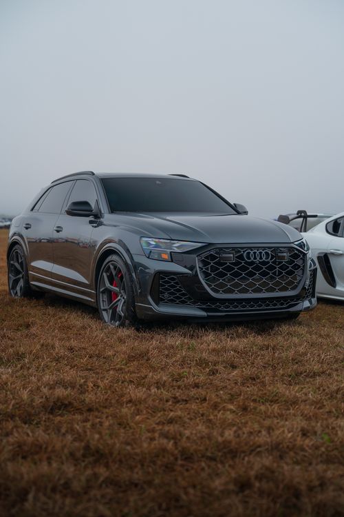 Free High-end luxury SUV with sleek design parked outdoors on a foggy day, showcasing modern automotive elegance. Stock Photo