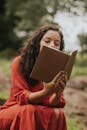 Woman Reading Book Outdoors in Nature