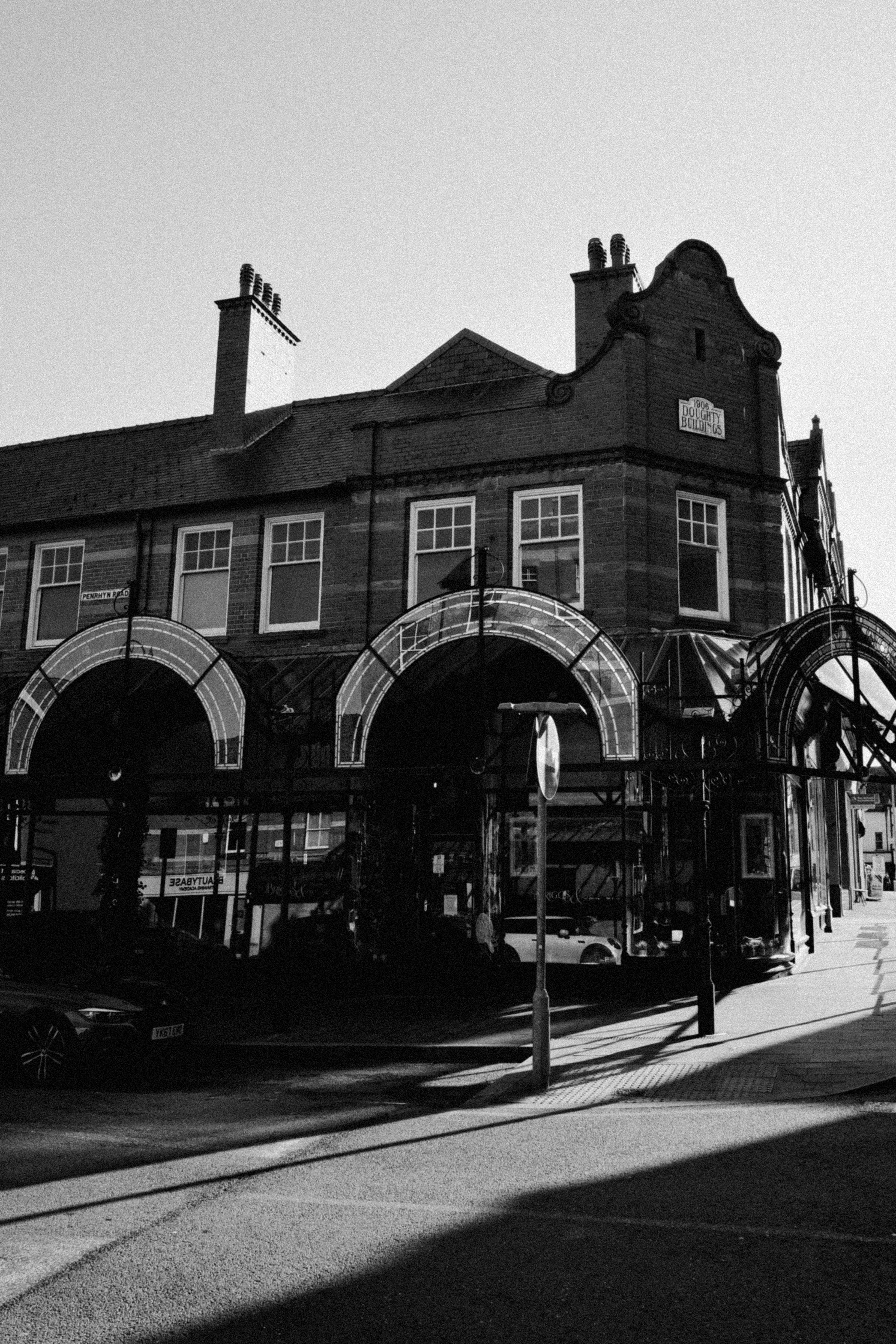 Black and white photo of a historic building in Colwyn Bay, Wales, showcasing its classic architecture.