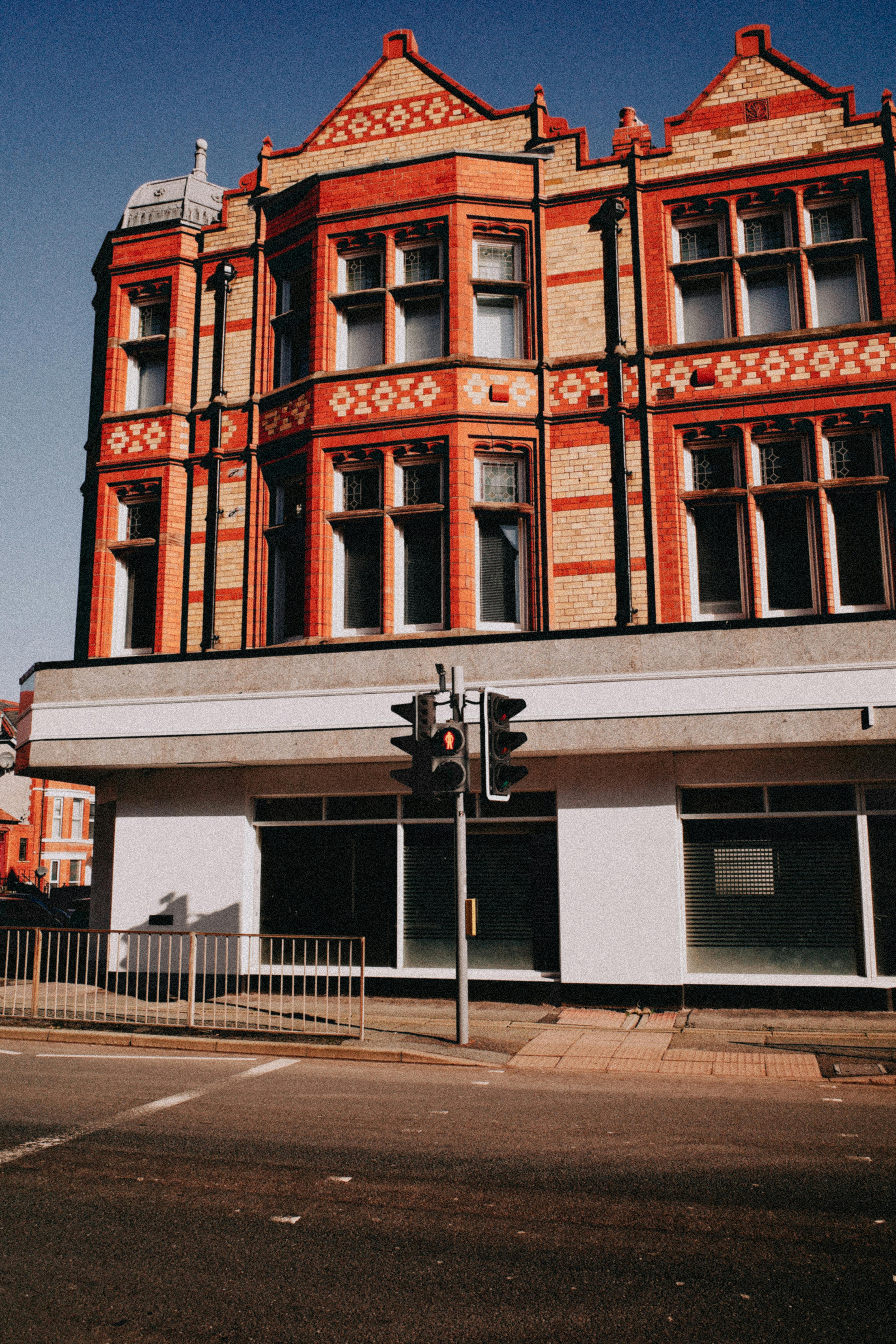 Victorian red brick building in Colwyn Bay, Wales, showcasing historic architecture.