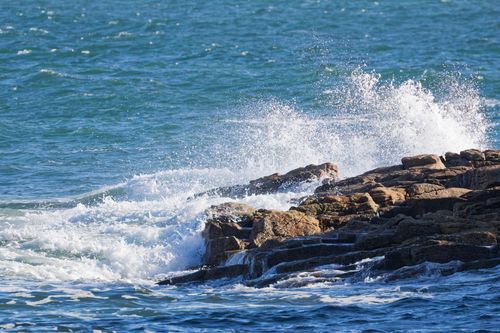 Free Dynamic ocean waves crashing against the rugged rocks of Ploemeur, Bretagne, France. Stock Photo