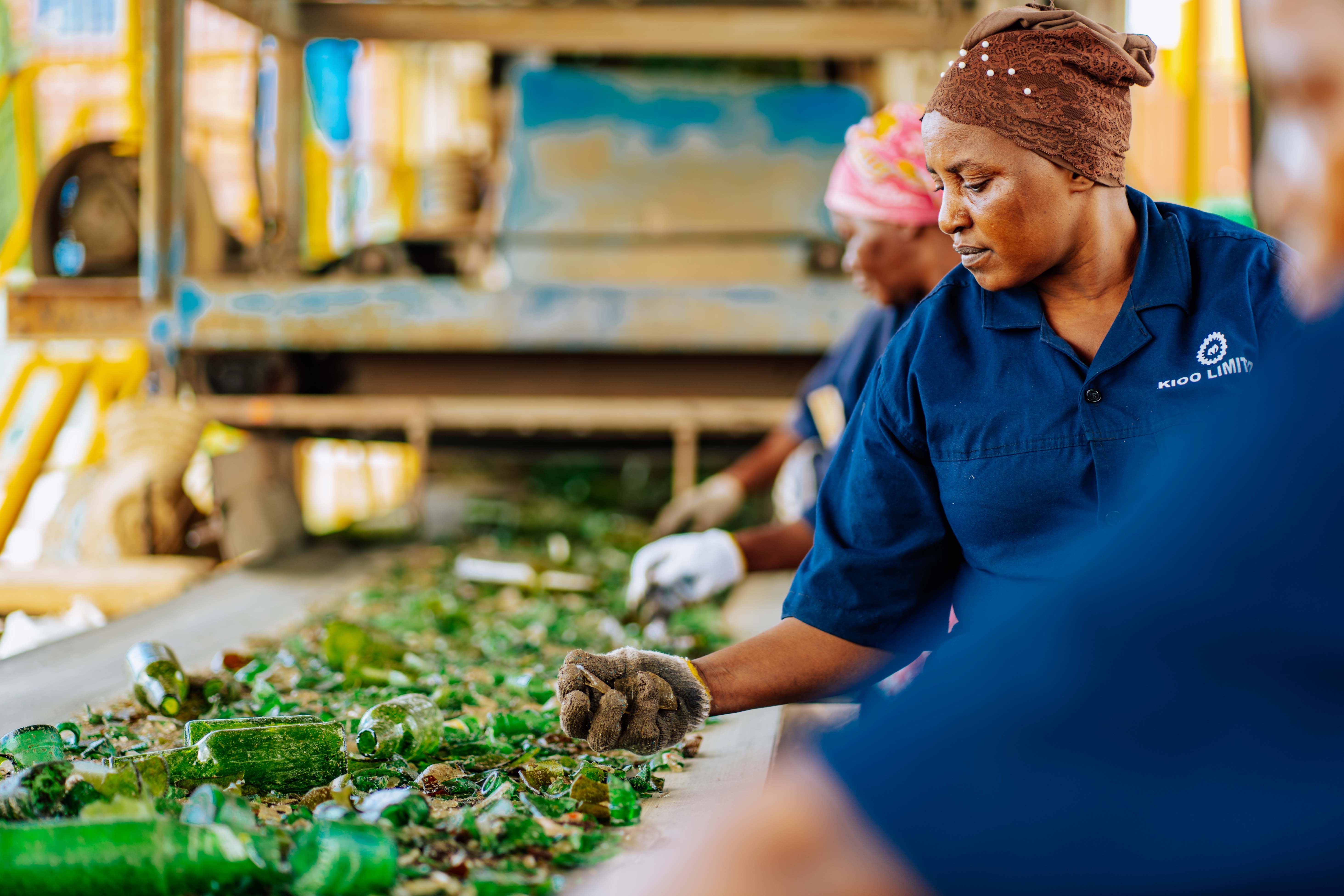 Women sorting broken glass at a recycling facility