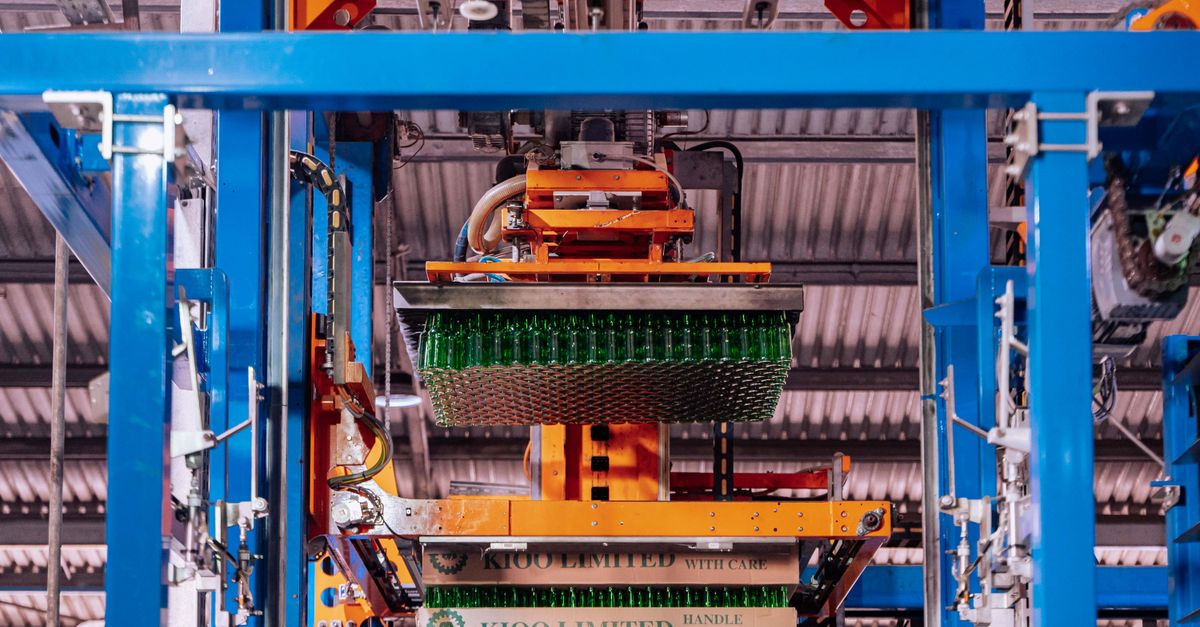 Glass manufacturing process at a factory in Dar es Salaam, showcasing automated machinery.