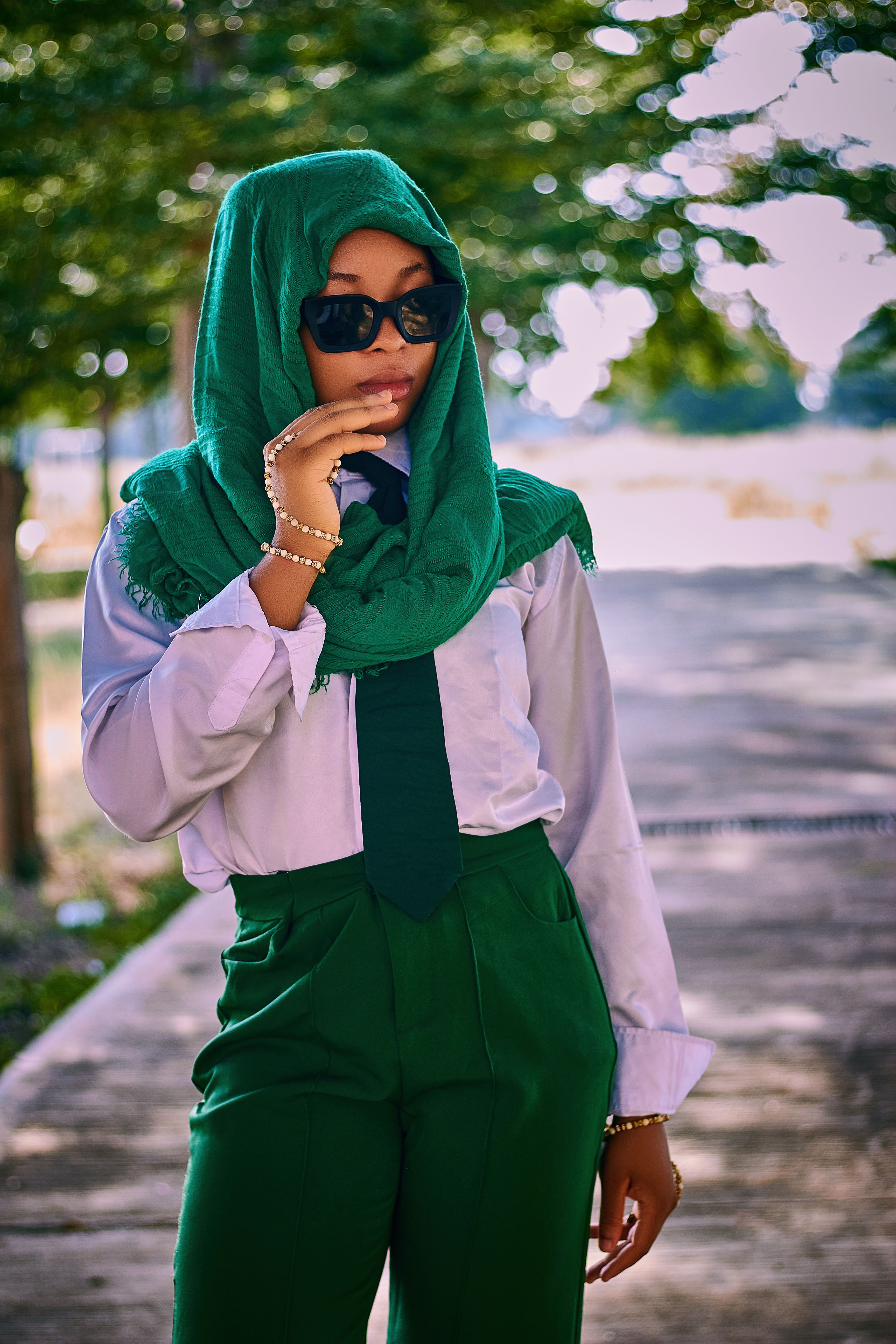 Stylish African Woman in Green Hijab and Sunglasses Outdoors