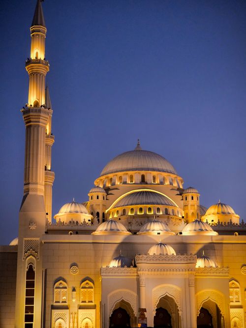 Free Beautifully illuminated mosque with intricate architecture during twilight, showcasing Islamic design. Stock Photo